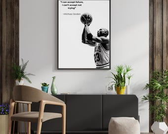 May include: Black and white framed print featuring Michael Jordan shooting a basketball. The print includes the quote "I can accept failure, I can't accept not trying" by Michael Jordan. The basketball player is wearing a jersey with the number 23.