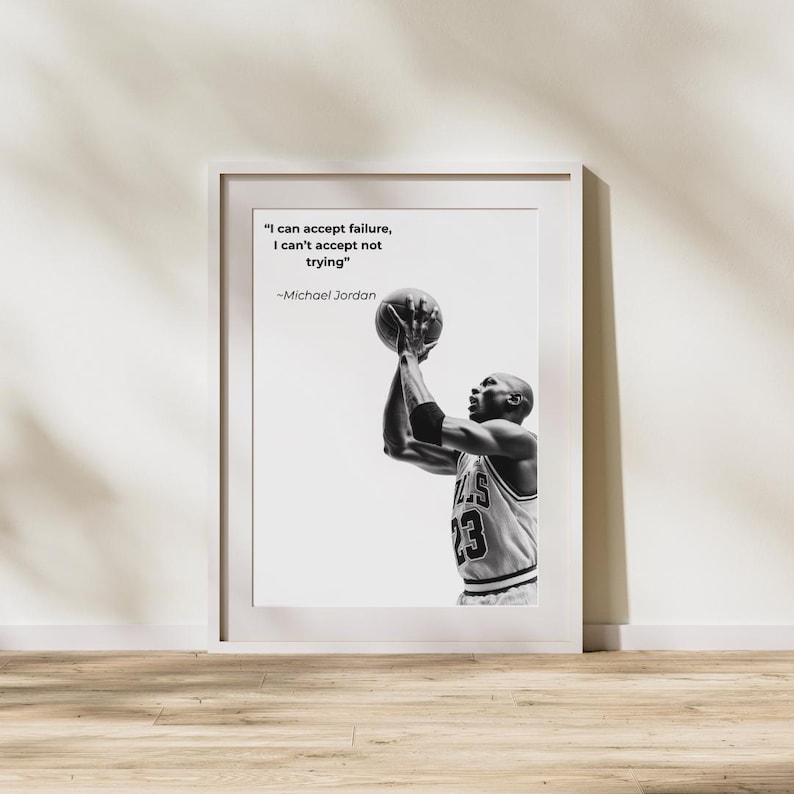 May include: Black and white framed print featuring Michael Jordan shooting a basketball. The print includes the quote "I can accept failure, I can't accept not trying" by Michael Jordan.