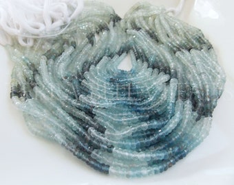 Puede incluir: Una hebra de cuentas de aguamarina azul claro, con un degradado de color de azul claro a azul oscuro. Las cuentas son facetadas y tienen un acabado liso y pulido.