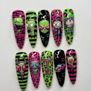 May include: A set of ten long, pointed artificial nails with cartoon character designs. The nails feature vibrant colors like pink, green, and black, with various patterns including stripes, leopard print, and stars. Each nail showcases a different character.