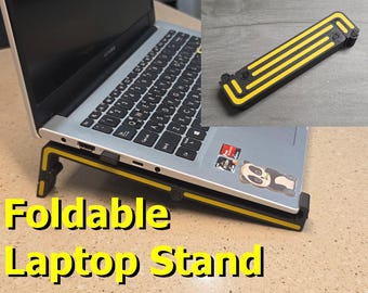 May include: A foldable laptop stand featuring a black frame with bright yellow accents. The stand is shown supporting a silver laptop and also in a collapsed, folded position. The text "Foldable Laptop Stand" is displayed in large yellow letters.