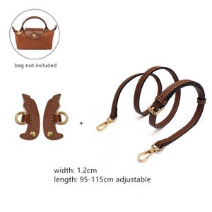 May include: Brown leather handbag strap with gold-tone hardware, including a buckle and two swivel clasps. The strap is adjustable from 37.4 to 45.3 inches. Also included are two brown leather pieces with gold-tone rings. The width is 0.5 inches.