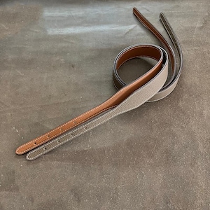 May include: A set of three ceramic mugs with a speckled, matte finish in cream, light grey, and dark grey. Each mug has a simple, minimalist design and a rounded handle.