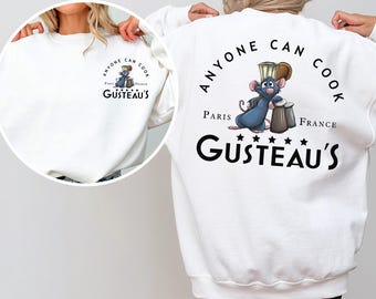 May include: White sweatshirt featuring a cartoon rat chef with the text "Anyone Can Cook" and "Gusteau's Paris France". The design is on the front and back of the sweatshirt. The word "WHITE" is at the bottom.