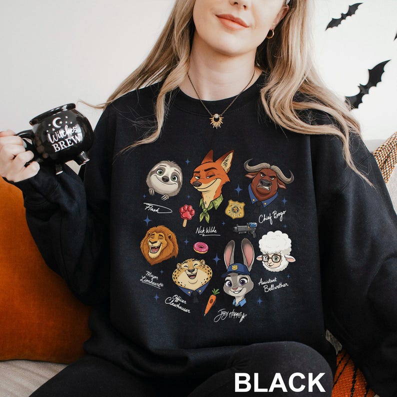 May include: Black sweatshirt featuring cartoon illustrations of characters from a popular animated movie. The design includes a sloth, fox, lion, and other animal characters. The word "BLACK" is printed at the bottom.