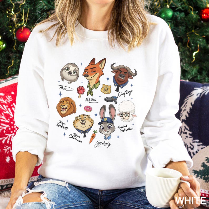 May include: White sweatshirt featuring cartoon illustrations of characters from the movie Zootopia. The characters include Flash, Nick Wilde, Chief Bogo, Mayor Lionheart, Officer Clawhauser, Judy Hopps, and others. The word "WHITE" is printed on the bottom right.