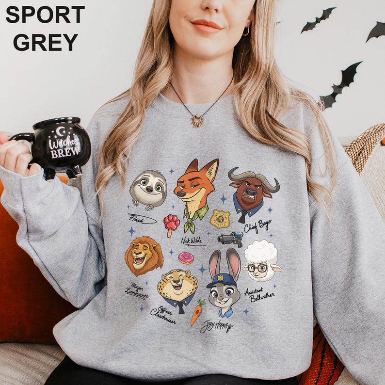 May include: A light grey sweatshirt with cartoon character illustrations. The sweatshirt features characters like Flash the sloth, Nick Wilde the fox, and Judy Hopps the bunny. The text "SPORT GREY" is at the top.