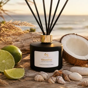May include: A black reed diffuser bottle with a gold collar and black reeds. The white label reads 6S Sixth Scents Shoreline Fresh Lime | Creamy Coconut Luxury Reed Diffuser | 200ml. It is surrounded by fresh lime slices, a coconut half, and seashells.