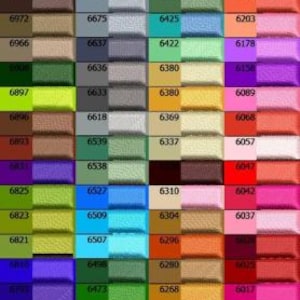 May include: A color chart featuring a grid of various fabric swatches. Each swatch displays a different color, with corresponding numerical codes. The colors range from vibrant hues to muted tones, including shades of pink, green, blue, and brown.
