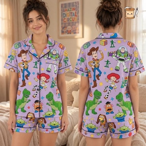May include: A lavender pajama set featuring a short-sleeved button-down shirt and matching shorts. The fabric is covered in a colorful repeating pattern of Toy Story characters including Woody, Buzz Lightyear, Jessie, Rex, Slinky Dog, and Mr. Potato Head.