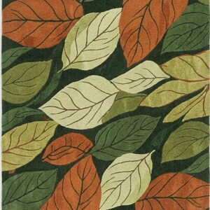 Hand tufted leaf pattern rug in olive green beige and rust colors