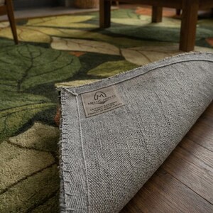 Hand tufted nature inspired rug with leaf design and soft texture