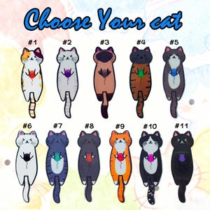 May include: A collection of eleven cat-shaped designs, each with a unique color scheme and holding a ball of yarn. The text "Choose Your cat" is arched across the top. Each cat is numbered from one to eleven.