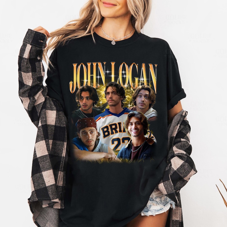 May include: A black short-sleeve t-shirt featuring the text JOHN LOGAN in gold lettering at the top, with a collage of five photographic portraits of the same individual in various outfits, including a sports jersey with the text BRIAN 22.