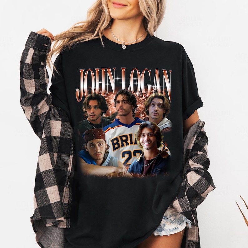 May include: A black short-sleeved t-shirt featuring a graphic print of the name JOHN LOGAN in a stylized font above a collage of five different photographs of the same person, layered over a glowing orange and red textured background.
