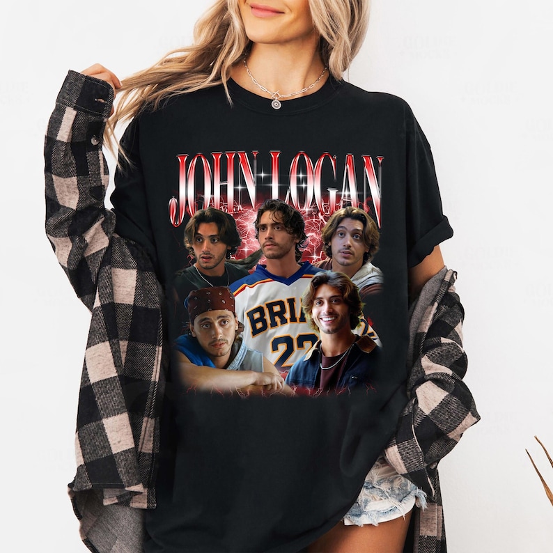 May include: A black t-shirt featuring a graphic print of the name JOHN LOGAN in red and white lettering above a collage of five photographs of the same individual in various outfits, including a sports jersey with the text BRIAN 22.