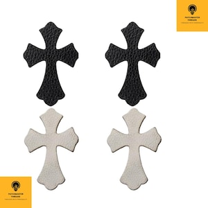Può includere: Quattro toppe a forma di croce in pelle nera e bianco sporco. Le croci hanno un aspetto strutturato e un design decorativo e stilizzato. Le toppe sono disposte in una formazione quadrata su sfondo bianco. Il logo del marchio si trova in alto a destra e in basso a sinistra.