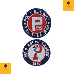 May include: Two circular embroidered patches. The top patch has a red centre with a white "P" and an American flag design. The words "POLO RALPH LAUREN EST. 1967" are in a blue border. The bottom patch has a similar design with "POLO RALPH LAUREN 1967".