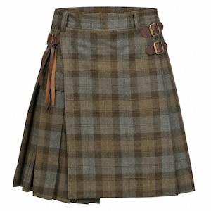 May include: A knee-length kilt featuring a brown and grey plaid pattern. The garment includes a flat front panel, pleated sides, and a waistband with two brown leather side straps with brass-toned metal buckles for an adjustable fit.