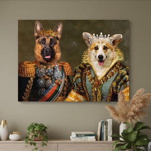 May include: A canvas print depicting two dogs in royal clothing. A German Shepherd wears a gold crown and military uniform. A Corgi wears a jeweled crown and a teal and gold gown. The background is a muted green.