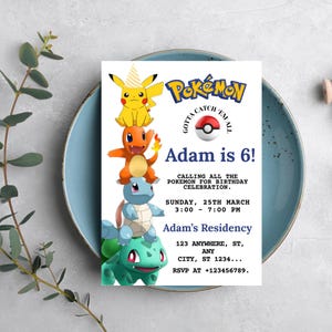 May include: A white invitation card with the Pokémon logo and characters, including Pikachu, Charmander, Squirtle, and Bulbasaur. The text reads "Adam is 6!" and includes party details. The card is on a blue plate.