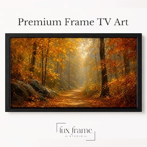 Può includere: Una cornice nera rettangolare contenente un'opera d'arte digitale di un sentiero forestale autunnale con fogliame arancione e giallo vibrante, luce solare che filtra tra gli alberi e terreno roccioso. Appaiono il testo Premium Frame TV Art e lux frame studio.