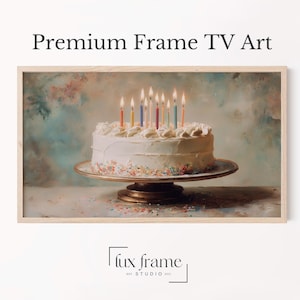 May include: A framed print of a birthday cake with lit candles. The cake is white with frosting and sprinkles, set on a decorative cake stand. The background is a soft, blurred painting with the text "Premium Frame TV Art".
