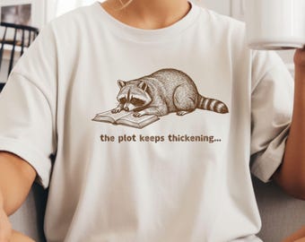 The Plot Keeps Thickening Comfort Colors Shirt, Funny Raccoon Reading TShirt, The Story Gets Wilder Tee, Book Lover Animal Shirt.