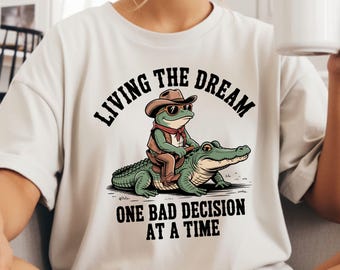 The Plot Keeps Thickening Comfort Colors Shirt, Funny Raccoon Reading TShirt, The Story Gets Wilder Tee, Book Lover Animal Shirt.