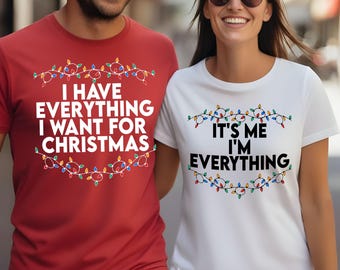 May include: A red t-shirt with the text "I HAVE EVERYTHING I WANT FOR CHRISTMAS" and a string of Christmas lights. A white t-shirt with the text "IT'S ME I'M EVERYTHING" and a string of Christmas lights.