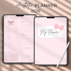 Op de afbeelding: Digitale esthetische planner voor 2026, met een roze en wit ontwerp. De planner bevat een dagelijkse indeling, takenlijsten en een sectie voor notities. De cover toont "My Planner" met een roze strik. Een stylus is inbegrepen.