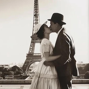 May include: A black and white photograph of a couple kissing in front of the Eiffel Tower. The woman wears a white dress and hat, while the man is in a suit and hat. The iconic Parisian landmark is in the background.