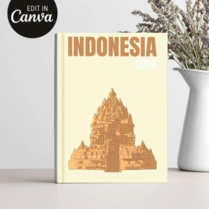 May include: A cream-colored notebook with the word "INDONESIA" in brown block letters and the year "2025". The cover features a detailed illustration of a temple in shades of brown. The words "EDIT IN Canva" are in a black circle in the upper left corner.