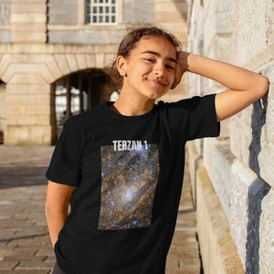 May include: A white ceramic mug with a black handle and the text "But First, Coffee" in a black, bold font. The mug is on a white surface.