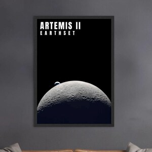 May include: Framed poster depicting a lunar landscape with a textured moon and a view of Earth against a black background. The poster includes the text "ARTEMIS II EARTHSET" at the top, ideal for space enthusiasts.