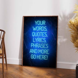 May include: A rectangular wall art print in a dark wood frame featuring a glowing neon blue sign effect against a dark background. The text reads: YOUR WORDS, QUOTES, LYRICS, PHRASES AND MORE GO HERE! in a bright cyan sans-serif font style.
