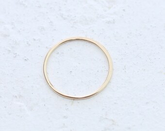 May include: A simple gold band ring, a minimalist jewelry piece.