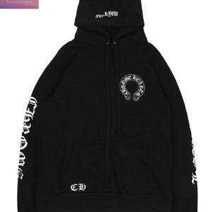 May include: Black hoodie with white lettering and graphics. The hoodie has a drawstring hood, a kangaroo pocket, and the text "Chrome Hearts" on the sleeves. The front displays a "Chrome Hearts" logo and the letters "CH".
