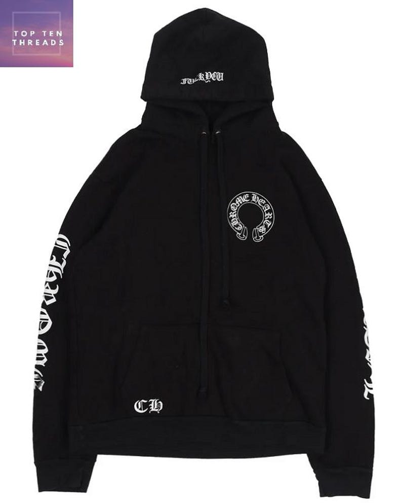 May include: Black hoodie with white lettering and graphics. The hoodie has a drawstring hood, a kangaroo pocket, and the text "Chrome Hearts" on the sleeves. The front displays a "Chrome Hearts" logo and the letters "CH".