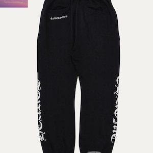 May include: Black sweatpants with white lettering down the side and on the back. The text on the back says "*FUCK YOU*". The sweatpants have a drawstring waist and pockets. The brand name "TOP TEN THREADS" is in the top left corner.