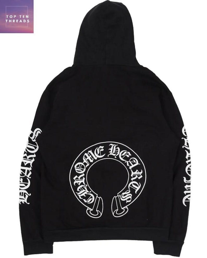 May include: Black hooded sweatshirt featuring white lettering on the sleeves and a large white graphic on the back. The graphic reads "Chrome Hearts" in a circular design. The brand name "Top Ten Threads" is in the upper left corner.