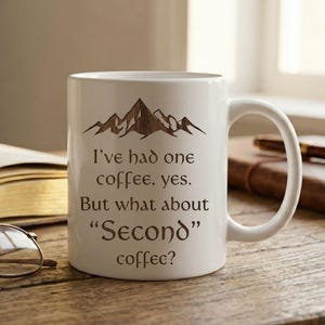 May include: A set of three ceramic mugs with a speckled, matte finish. The mugs are in shades of cream, gray, and black. Each mug has a simple, modern design, perfect for coffee or tea.