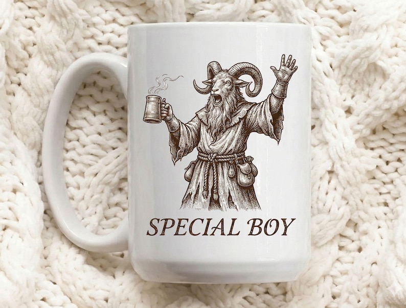 May include: White ceramic mug featuring a detailed illustration of a goat-like figure in robes, holding a mug of steaming liquid and raising a hand. The text "SPECIAL BOY" is printed in brown below the illustration. The mug has a large handle.