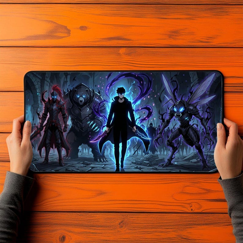 May include: A rectangular desk mat featuring a dark fantasy illustration of a central figure in a black coat surrounded by a glowing blue aura, flanked by a red-armoured knight, a large armoured bear, and a winged insectoid creature in a stone ruin.