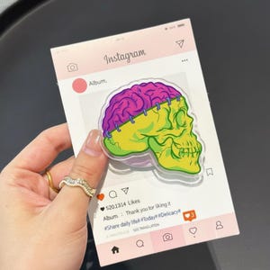May include: A pink Instagram-themed card with a colorful skull and brain graphic. The skull is yellow and green, and the brain is purple. The card has the Instagram logo and text, including "Album," and "5201314 Likes."