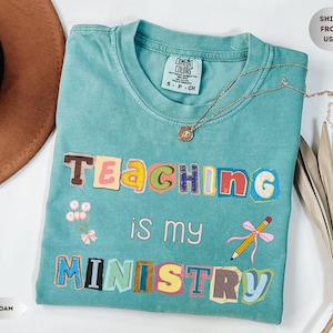 May include: A set of three ceramic mugs with a speckled, matte finish. The mugs are in shades of cream, light gray, and dark gray. Each mug has a simple, minimalist design and a rounded handle.