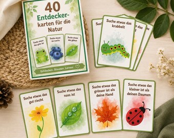 May include: A set of 40 nature discovery cards featuring illustrations of a frog, blueberries, a leaf, a caterpillar, a yellow flower, and a ladybug. Each card includes German text prompts for outdoor exploration, such as finding things that are green, round, shiny, crawling, wet, or specific sizes.
