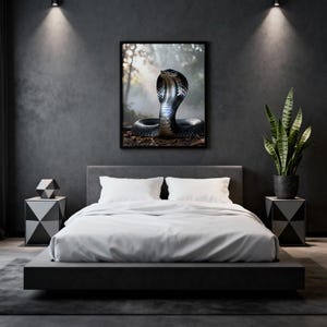 May include: A framed print of a cobra snake with its hood expanded. The snake is black and grey with a detailed pattern. The background is a blurred forest scene. The print is displayed above a bed in a modern bedroom setting.
