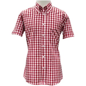 Könnte beinhalten: Ein kurzärmeliges Hemd mit rot-weißem Karomuster. Das Hemd hat einen Button-Down-Kragen und eine Brusttasche. Der Stoff scheint eine leichte Baumwolle oder Mischung zu sein.