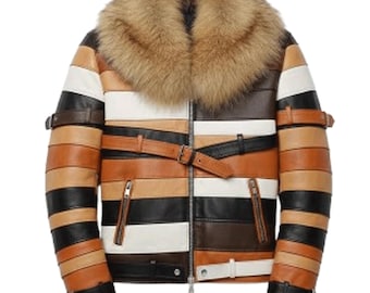 May include: A multi-colored leather jacket with a fur collar. The jacket features horizontal stripes in shades of brown, black, white, and tan. It has a zipper closure, two front pockets, and adjustable straps with buckles. The jacket is a statement piece.